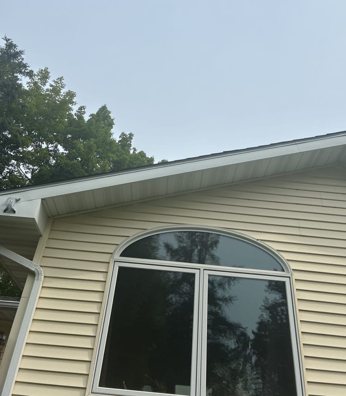 Finished eave and gutter above an arched window