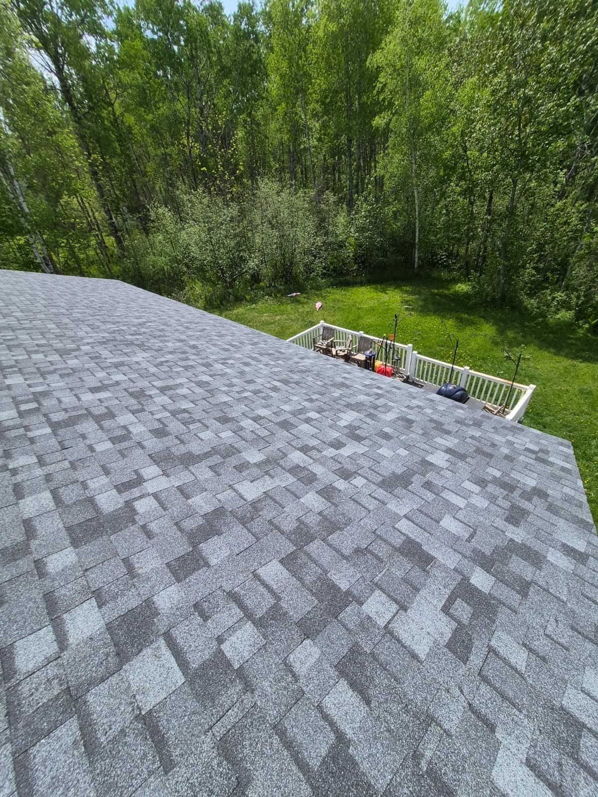 New gray architectural shingles over the deck side of the house
