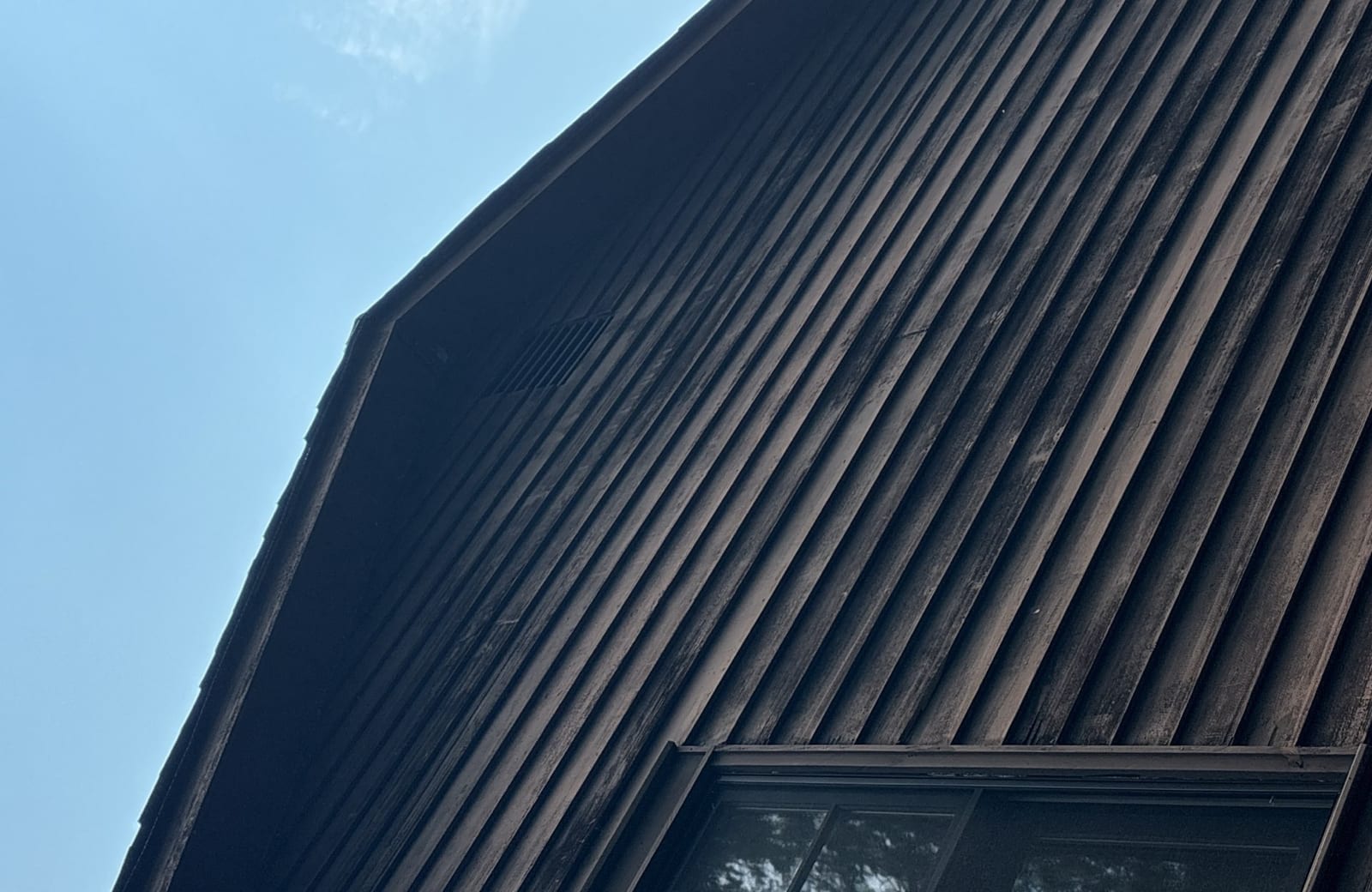 New dark LP SmartSide siding up to the roofline